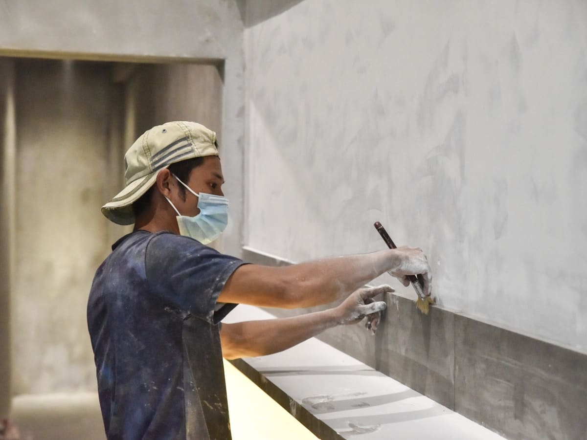 A plasterer skimming a wall