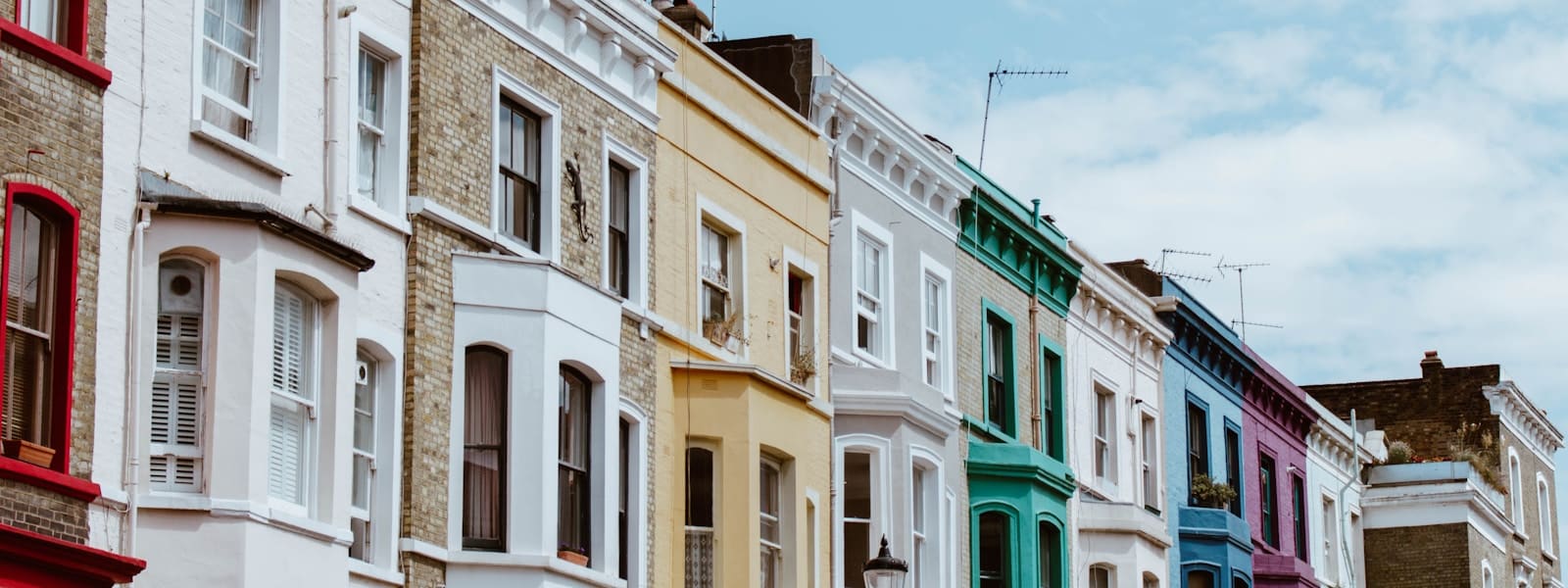 A terrace of pastel-painted houses in west London